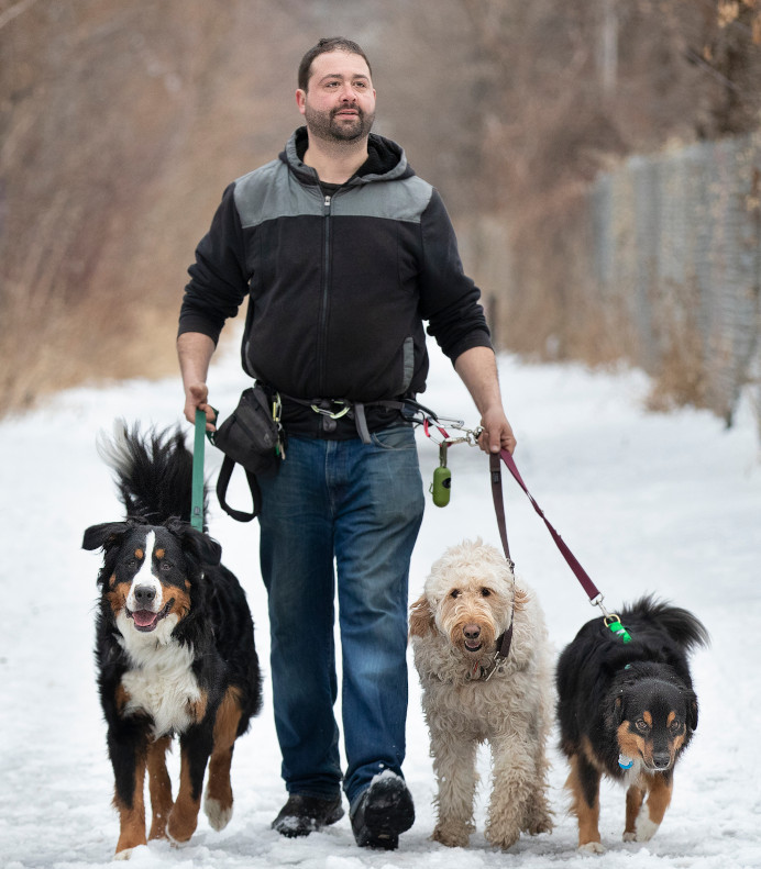 Byron walking three dogs in the snow